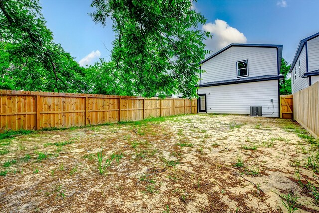 fenced backyard featuring central air condition unit