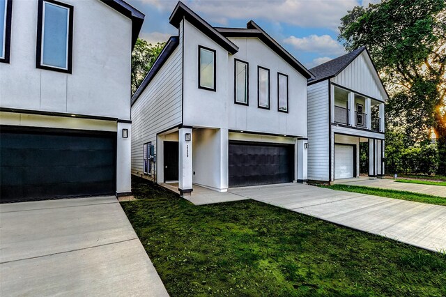 view of front of house featuring an attached garage, stucco siding, and board and batten siding