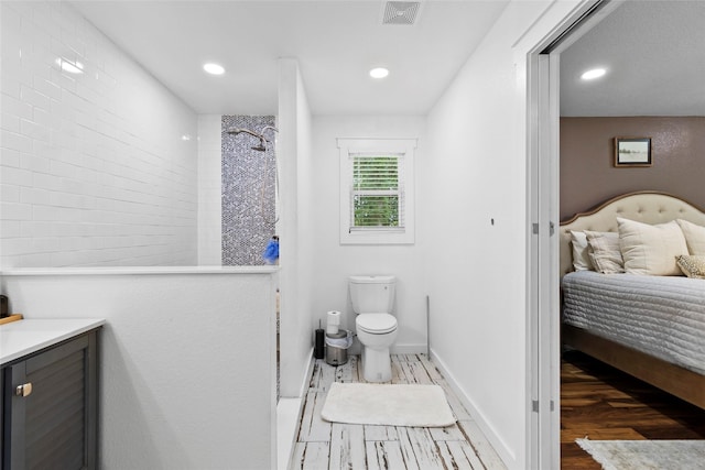 452 N Ghost Branch Rd, Trinity, TX 75862 - bathroom featuring walk in shower, toilet, visible vents, and wood finished floors