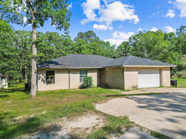 452 N Ghost Branch Rd, Trinity, TX 75862 - ranch-style house featuring roof with shingles, an attached garage, brick siding, concrete driveway, and cooling unit