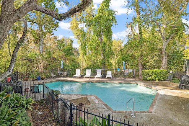 pool featuring fence and a patio area