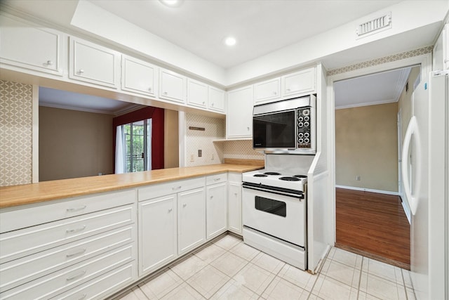 kitchen featuring white cabinets, visible vents, white appliances, light countertops, and ornamental molding