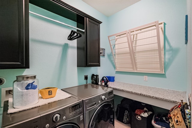 laundry area featuring washing machine and dryer and cabinet space