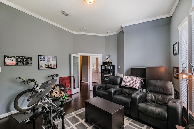 living room featuring crown molding, french doors, visible vents, and wood finished floors