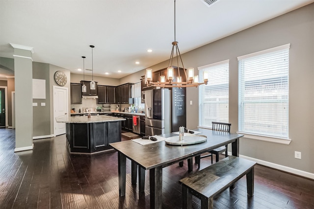 dining space featuring a chandelier, dark wood-style flooring, baseboards, and recessed lighting
