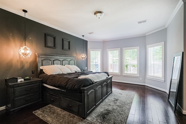 bedroom with visible vents, dark wood-style flooring, baseboards, a chandelier, and ornamental molding