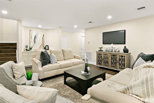 living area with visible vents, wood finished floors, stairway, and recessed lighting