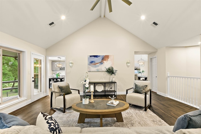 living area featuring visible vents, wood finished floors, and high vaulted ceiling