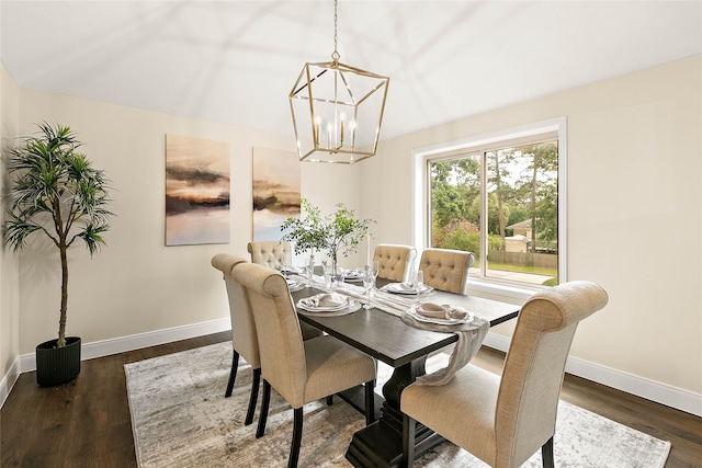 dining space with baseboards, dark wood finished floors, and an inviting chandelier
