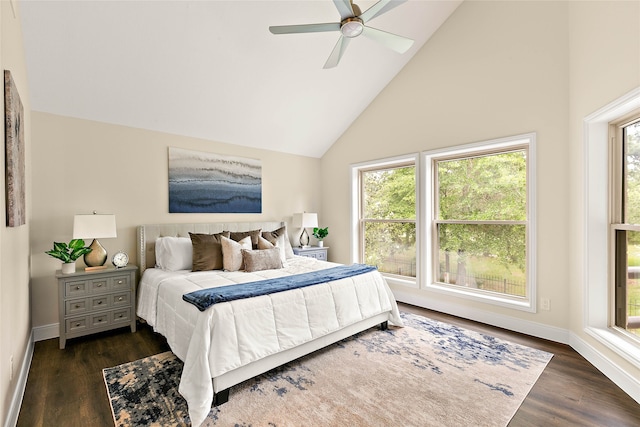 bedroom featuring baseboards, dark wood-style flooring, high vaulted ceiling, and a ceiling fan