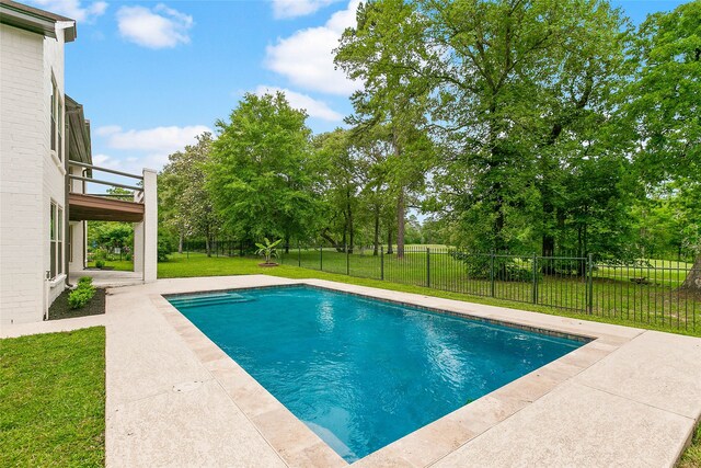 view of pool with a lawn, a patio, a fenced in pool, and fence