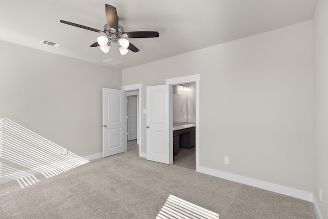 15214 Prairie Mill Dr, New Caney, TX 77357 - unfurnished bedroom with light carpet, baseboards, connected bathroom, and a ceiling fan