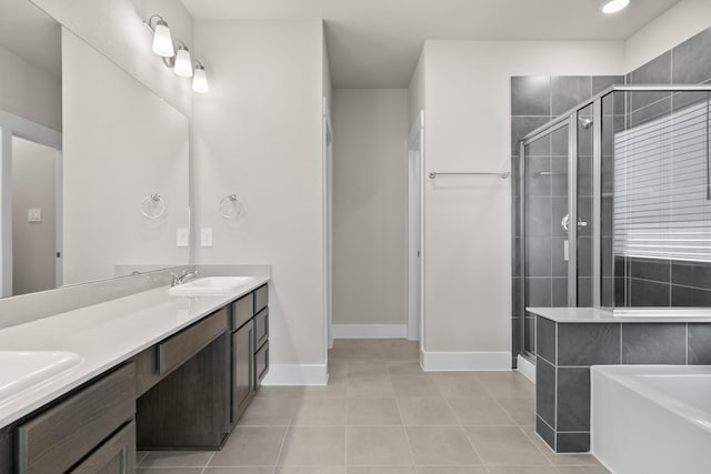 15214 Prairie Mill Dr, New Caney, TX 77357 - bathroom with tile patterned flooring, a shower stall, a bath, double vanity, and baseboards