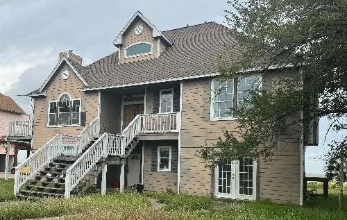 115 8th St, San Leon, TX 77539 - exterior space featuring stairway and a chimney