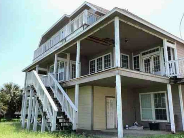 115 8th St, San Leon, TX 77539 - back of house featuring stairway and a balcony
