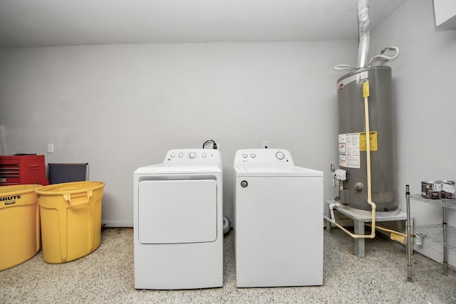 laundry room with water heater, washer and clothes dryer, and laundry area