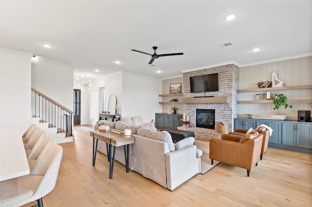 4233 Padova Cir, College Station, TX 77845 - living area featuring light wood-type flooring, visible vents, ceiling fan with notable chandelier, and ornamental molding