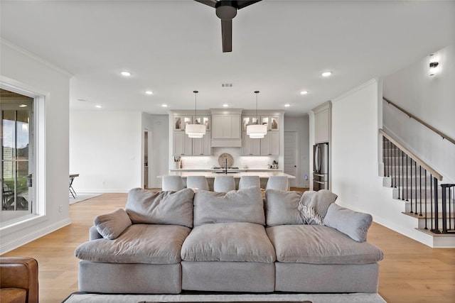 4233 Padova Cir, College Station, TX 77845 - living room featuring stairway, light wood-style flooring, and recessed lighting