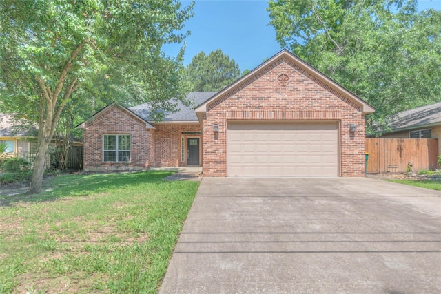 single story home featuring a garage, fence, concrete driveway, a front yard, and brick siding