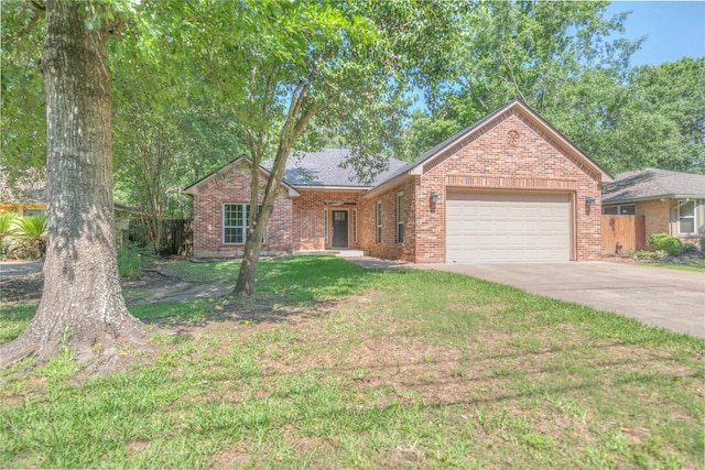 ranch-style home featuring fence, brick siding, driveway, a garage, and a front yard