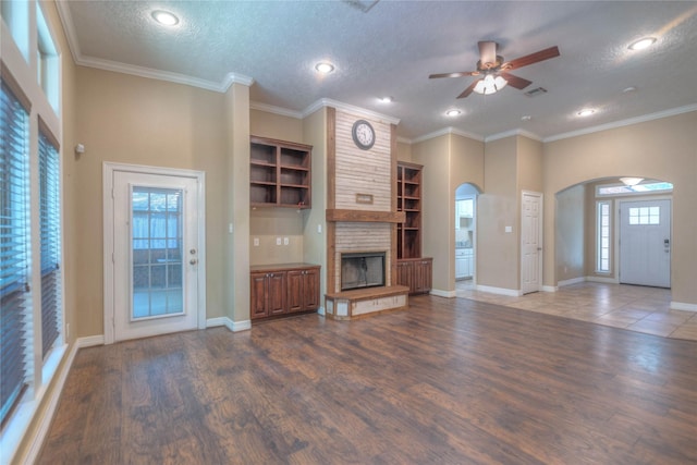 unfurnished living room with wood finished floors, visible vents, recessed lighting, arched walkways, and a ceiling fan