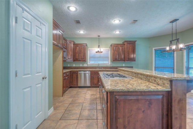 kitchen with an inviting chandelier, visible vents, and appliances with stainless steel finishes