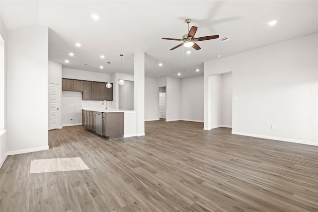 unfurnished living room with light wood finished floors, baseboards, a ceiling fan, and recessed lighting