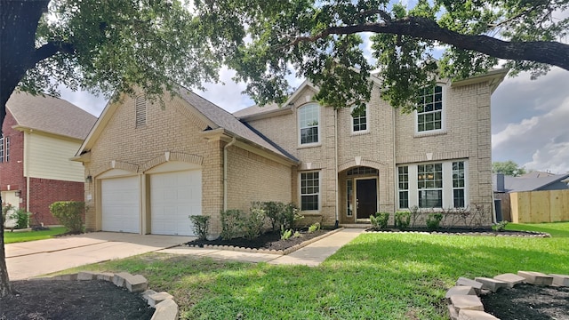traditional-style house featuring an attached garage, fence, a front yard, brick siding, and driveway