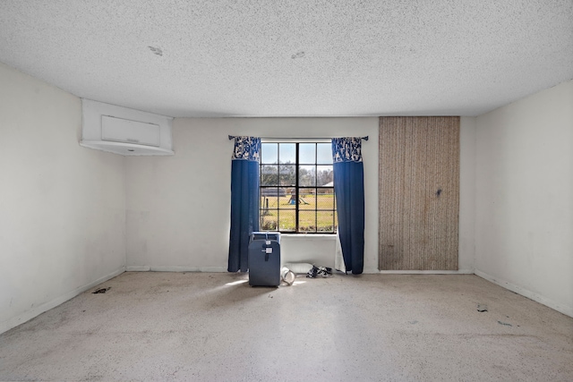 7009 Ave Ave N, Santa Fe, TX 77510 - spare room with a textured ceiling, baseboards, and speckled floor