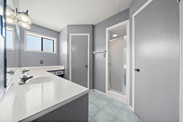 7009 Ave Ave N, Santa Fe, TX 77510 - bathroom featuring a stall shower, tile patterned floors, vanity, and a textured ceiling