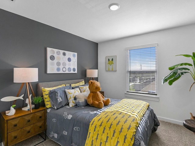 bedroom featuring carpet flooring and baseboards