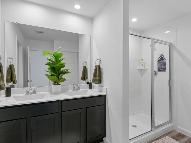 full bath featuring visible vents, a shower stall, and a sink