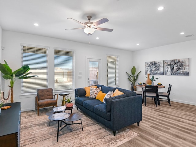 living area with ceiling fan, light wood-style flooring, baseboards, and recessed lighting