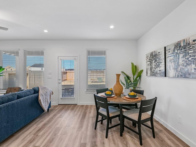 dining room featuring baseboards, light wood-style flooring, and recessed lighting