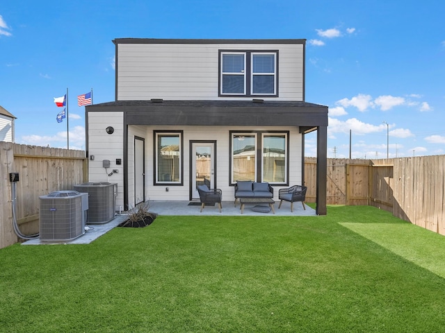 rear view of property with a yard, central air condition unit, and a patio