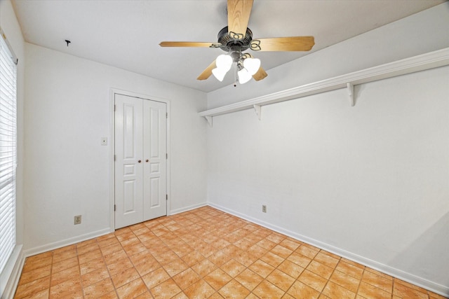 unfurnished bedroom with baseboards, a closet, and ceiling fan