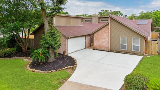 mid-century inspired home featuring fence, concrete driveway, a front lawn, and brick siding