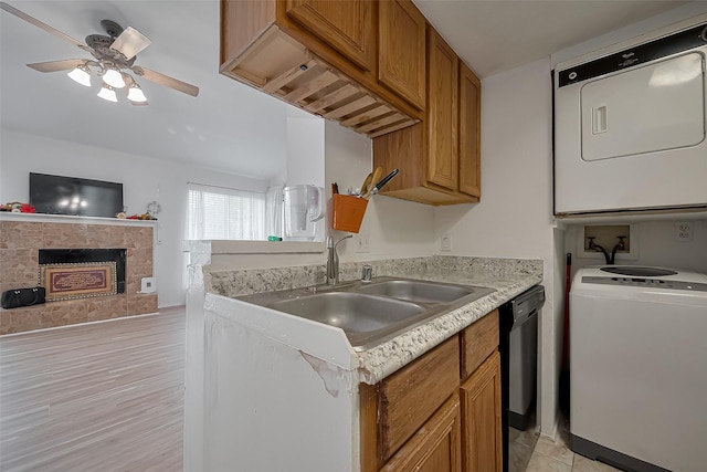 9009 Richmond Ave Unit 613, Houston, TX 77063 - kitchen with range, stacked washer / drying machine, brown cabinets, a ceiling fan, and light countertops