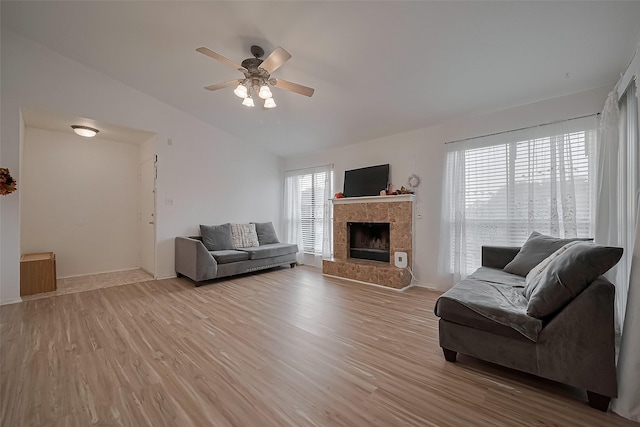 9009 Richmond Ave Unit 613, Houston, TX 77063 - living room with light wood-style flooring, ceiling fan, a fireplace, and lofted ceiling