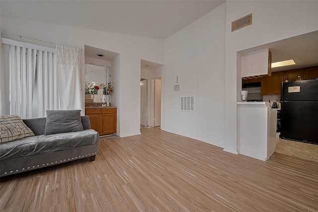 9009 Richmond Ave Unit 613, Houston, TX 77063 - living area featuring light wood finished floors and high vaulted ceiling