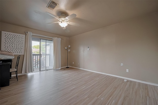 9009 Richmond Ave Unit 613, Houston, TX 77063 - unfurnished living room featuring baseboards, ceiling fan, and light wood-style flooring