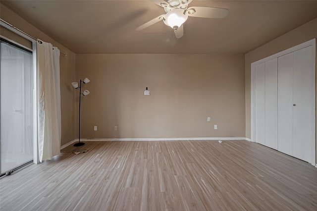 9009 Richmond Ave Unit 613, Houston, TX 77063 - unfurnished bedroom featuring light wood-type flooring, baseboards, and a ceiling fan