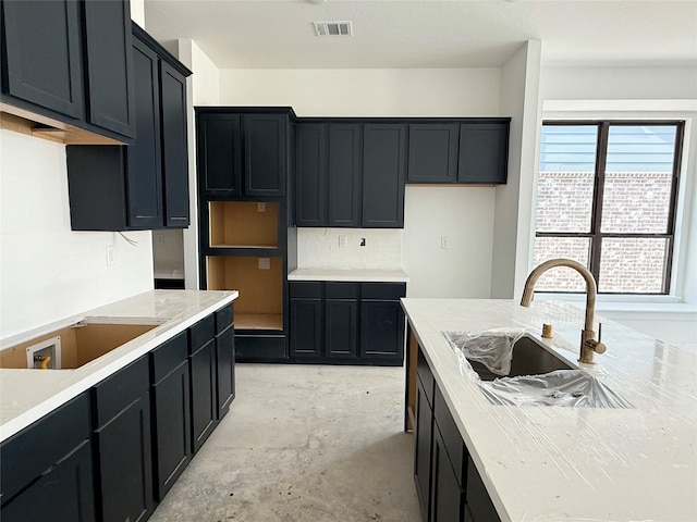 6126 Severson Lk, Katy, TX 77493 - kitchen featuring concrete floors, visible vents, dark cabinetry, and a sink