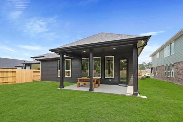 6126 Severson Lk, Katy, TX 77493 - back of house featuring a patio, roof with shingles, fence, and a lawn