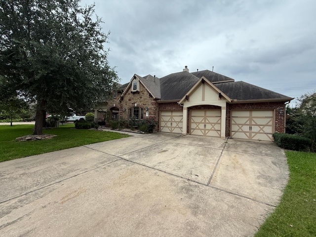 4315 Sanctuary Hills Ct, Spring, TX 77388 - view of front of home with a chimney, brick siding, an attached garage, concrete driveway, and a front yard