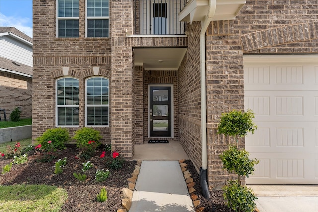 1226 Tilia Creek Ln, Montgomery, TX 77316 - view of exterior entry with brick siding, a balcony, and a garage