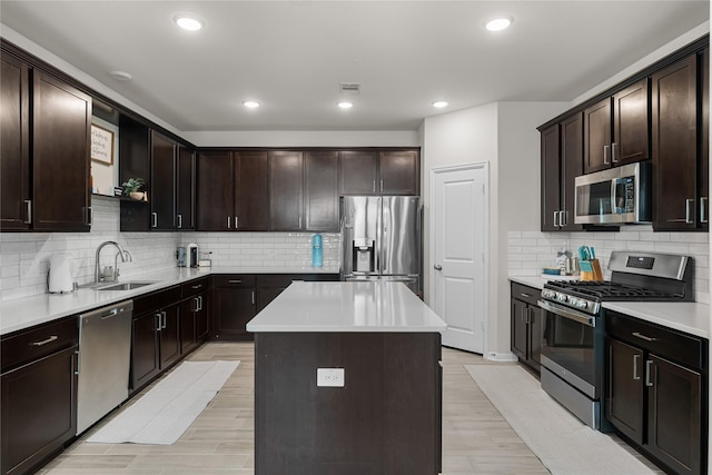 1226 Tilia Creek Ln, Montgomery, TX 77316 - kitchen featuring stainless steel appliances, a sink, decorative backsplash, a center island, and dark brown cabinetry