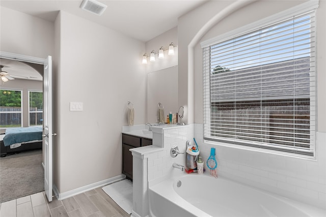 1226 Tilia Creek Ln, Montgomery, TX 77316 - full bath featuring a garden tub, ensuite bath, vanity, a ceiling fan, and baseboards