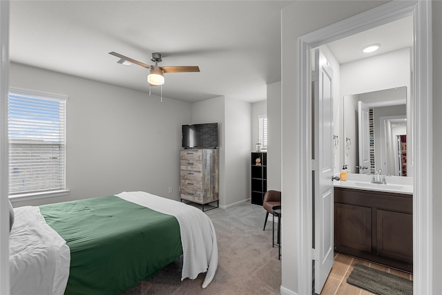 1226 Tilia Creek Ln, Montgomery, TX 77316 - bedroom featuring a sink, multiple windows, baseboards, and ensuite bath
