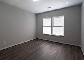 empty room with baseboards, dark wood-style floors, and recessed lighting